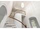 Elegant curved staircase with wood railing and white spindles at 636 Pendleton Lake Rd, Raleigh, NC 27614