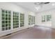 Bright sunroom with large windows overlooking the wooded backyard and natural light at 636 Pendleton Lake Rd, Raleigh, NC 27614