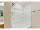 Clean bathroom with a shower-tub combo featuring a built-in shelving unit and modern fixtures at 6617 Whitted Rd, Fuquay Varina, NC 27526
