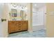 Bright bathroom featuring a double vanity with contemporary design elements, a shower-tub combo, and hexagon tile floors at 6617 Whitted Rd, Fuquay Varina, NC 27526