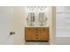 Stylish bathroom featuring a double vanity with modern fixtures and unique hexagonal tile flooring at 6617 Whitted Rd, Fuquay Varina, NC 27526