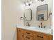 Elegant bathroom with a double vanity, stylish mirrors, and modern lighting fixtures, providing a luxurious feel at 6617 Whitted Rd, Fuquay Varina, NC 27526
