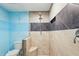 Modern bathroom featuring a tiled shower with bench, clear glass enclosure and updated fixtures at 6617 Whitted Rd, Fuquay Varina, NC 27526
