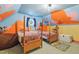 Themed bedroom with two beds and custom painted walls featuring whimsical elements at 6617 Whitted Rd, Fuquay Varina, NC 27526