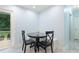 Cozy breakfast nook featuring a black round table, chairs, and sliding glass door to outdoor living at 6617 Whitted Rd, Fuquay Varina, NC 27526