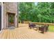 Spacious wooden deck with outdoor seating, perfect for enjoying the surrounding greenery at 6617 Whitted Rd, Fuquay Varina, NC 27526