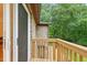 Outdoor deck with wooden railing and views of the surrounding trees and natural landscape at 6617 Whitted Rd, Fuquay Varina, NC 27526