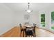 Bright dining room with hardwood floors, a chandelier, and a large window at 6617 Whitted Rd, Fuquay Varina, NC 27526