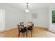 Formal dining room with hardwood floors, a chandelier, and a garden view at 6617 Whitted Rd, Fuquay Varina, NC 27526