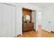 Inviting entryway with wood floors, classic dresser with mirror, and ample storage space with white closet doors at 6617 Whitted Rd, Fuquay Varina, NC 27526