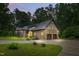 Inviting brick home featuring an attached two-car garage, manicured lawn, and a spacious circular driveway at 6617 Whitted Rd, Fuquay Varina, NC 27526