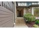 Inviting front entryway with brick steps, a wooden door with a wreath, and tasteful landscaping at 6617 Whitted Rd, Fuquay Varina, NC 27526