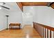 Hallway with wooden floors and trim, showcasing the staircase and banister that lead to the rooms at 6617 Whitted Rd, Fuquay Varina, NC 27526