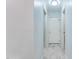 Hallway with doors, white trim, neutral wall paint, and marble flooring at 6617 Whitted Rd, Fuquay Varina, NC 27526