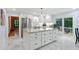 Bright kitchen showcasing a granite island, modern stainless-steel appliances, white cabinetry and deck access at 6617 Whitted Rd, Fuquay Varina, NC 27526