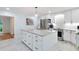 Spacious kitchen with a large island, white cabinets, stainless steel appliances, and modern lighting at 6617 Whitted Rd, Fuquay Varina, NC 27526
