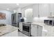 Close up of a bright kitchen featuring stainless steel appliances and granite countertops at 6617 Whitted Rd, Fuquay Varina, NC 27526