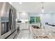 Bright kitchen featuring a granite island, stainless-steel appliances, and white cabinetry at 6617 Whitted Rd, Fuquay Varina, NC 27526