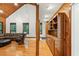 Bright living room featuring hardwood floors, a cozy sofa, and a charming wood-paneled accent wall at 6617 Whitted Rd, Fuquay Varina, NC 27526