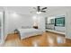 Bright main bedroom with en-suite bathroom, hardwood floors, and a ceiling fan, offering comfort and style at 6617 Whitted Rd, Fuquay Varina, NC 27526
