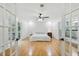Serene main bedroom featuring hardwood floors, a ceiling fan, and an en-suite bathroom with lots of natural light at 6617 Whitted Rd, Fuquay Varina, NC 27526