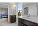 Bathroom featuring dual sink vanity, modern fixtures, and a window with natural light at 6949 Rex Rd, Holly Springs, NC 27540