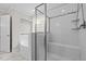 Stylish bathroom featuring a glass-enclosed shower with a built-in seat and a separate soaking tub at 6949 Rex Rd, Holly Springs, NC 27540
