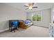 Bedroom featuring a bed, desk, and large window providing natural light at 6949 Rex Rd, Holly Springs, NC 27540