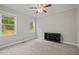 Bright bedroom with neutral walls, carpeted floors, and two windows offering views of the outdoors at 6949 Rex Rd, Holly Springs, NC 27540