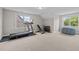 Spacious bonus room featuring a treadmill, workout bench, and large windows at 6949 Rex Rd, Holly Springs, NC 27540