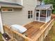 Outdoor wooden deck featuring a grill and direct access to a screened-in porch at 6949 Rex Rd, Holly Springs, NC 27540