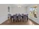 Formal dining room featuring hardwood floors, wainscoting, and comfortable seating at 6949 Rex Rd, Holly Springs, NC 27540