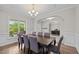 Elegant dining room with hardwood floors, chandelier, and decorative crown molding at 6949 Rex Rd, Holly Springs, NC 27540