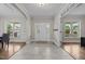Bright foyer with tile and hardwood flooring, showcasing an elegant entrance and access to various living spaces at 6949 Rex Rd, Holly Springs, NC 27540