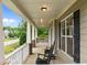 Spacious front porch perfect for relaxing, featuring classic columns and a view of the neighborhood at 6949 Rex Rd, Holly Springs, NC 27540