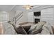 Comfortable living room featuring a fireplace, built-in shelving, ceiling fan, and staircase at 6949 Rex Rd, Holly Springs, NC 27540