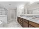 Elegant main bathroom with double vanity, decorative mirrors, and a glass-enclosed shower at 6949 Rex Rd, Holly Springs, NC 27540