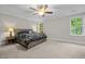 Relaxing main bedroom with ceiling fan, neutral walls, and ample natural light at 6949 Rex Rd, Holly Springs, NC 27540