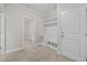 Functional mudroom with built-in storage, seating, and a convenient coat rack at 6949 Rex Rd, Holly Springs, NC 27540