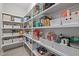 Organized pantry with white shelving and ample storage space for food and household items at 6949 Rex Rd, Holly Springs, NC 27540