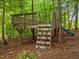 Backyard features a wooden climbing structure, ideal for active play in a natural setting at 6949 Rex Rd, Holly Springs, NC 27540