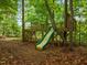 Features a wooden treehouse and slide for backyard fun and adventure for  at 6949 Rex Rd, Holly Springs, NC 27540