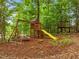 Backyard includes a wooden playset featuring a swing and slide, perfect for outdoor fun at 6949 Rex Rd, Holly Springs, NC 27540