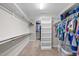 Organized walk-in closet with shelving, rods, and ample storage space for clothes and accessories at 6949 Rex Rd, Holly Springs, NC 27540