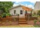 A charming back deck with a dining table, umbrella, and potted plants offers the perfect outdoor entertaining space at 729 Mial St, Raleigh, NC 27608