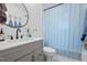 Modern bathroom featuring shiplap, dark fixtures, a large mirror and hexagon tile flooring at 729 Mial St, Raleigh, NC 27608