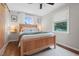 Bright bedroom features wood floors, two windows with natural light and a modern ceiling fan at 729 Mial St, Raleigh, NC 27608