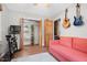 Functional bedroom with a pull-out couch and a wall-mounted guitar collection at 729 Mial St, Raleigh, NC 27608