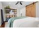 Bedroom featuring a wood sliding door and an industrial shelving unit on the side at 729 Mial St, Raleigh, NC 27608