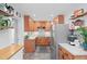 Kitchen with stainless steel appliances, light wood cabinets, and open shelving at 729 Mial St, Raleigh, NC 27608